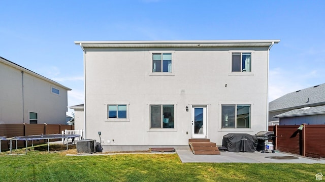 312 N 240 E, Vineyard, UT 84059 - back of property featuring entry steps, a trampoline, a patio area, and stucco siding