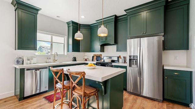 312 N 240 E, Vineyard, UT 84059 - kitchen with stainless steel appliances, green cabinets, light wood-type flooring, light countertops, and pendant lighting