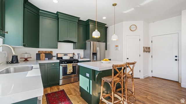 312 N 240 E, Vineyard, UT 84059 - kitchen featuring green cabinets, appliances with stainless steel finishes, light wood-style flooring, light countertops, and recessed lighting