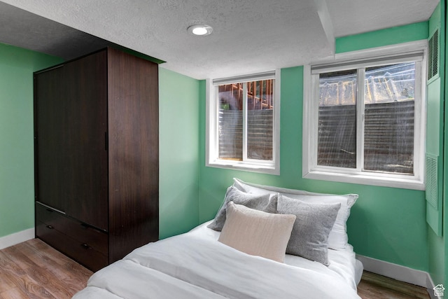 2953 W Wildflower Ct Unit 35, Park City, UT 84098 - bedroom with a textured ceiling and wood finished floors
