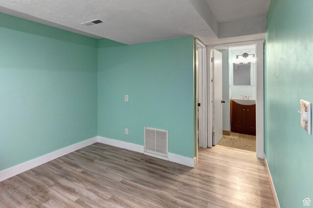 2953 W Wildflower Ct Unit 35, Park City, UT 84098 - spare room with light wood-type flooring and a textured ceiling