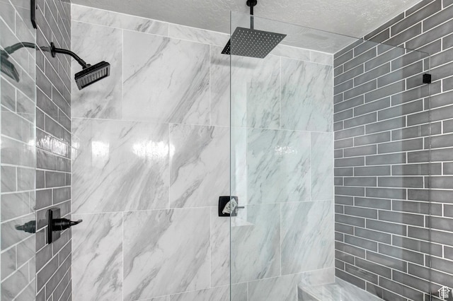 2953 W Wildflower Ct Unit 35, Park City, UT 84098 - bathroom with tiled shower and a textured ceiling