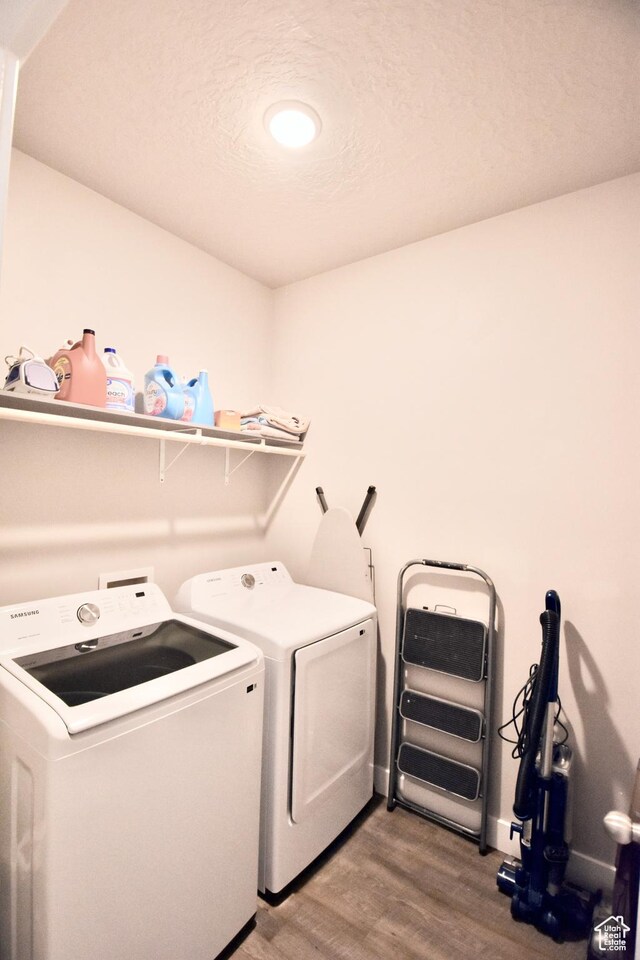 397 S Trejo Ridge Rd E, Grantsville, UT 84029 - laundry area with wood finished floors and washing machine and dryer