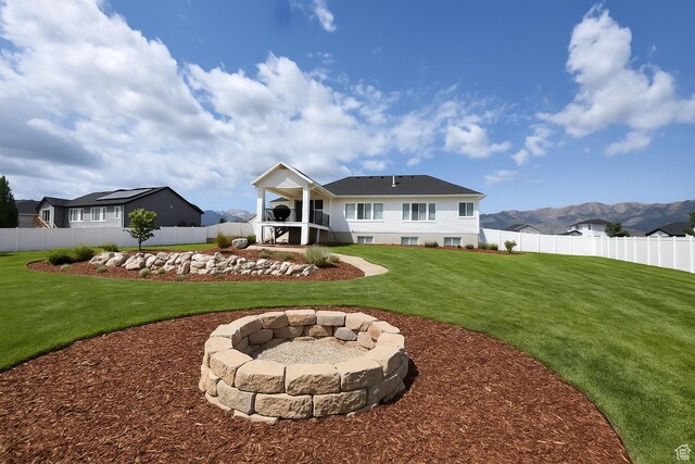 397 S Trejo Ridge Rd E, Grantsville, UT 84029 - back of house featuring a fenced backyard, a fire pit, stairway, and a mountain view