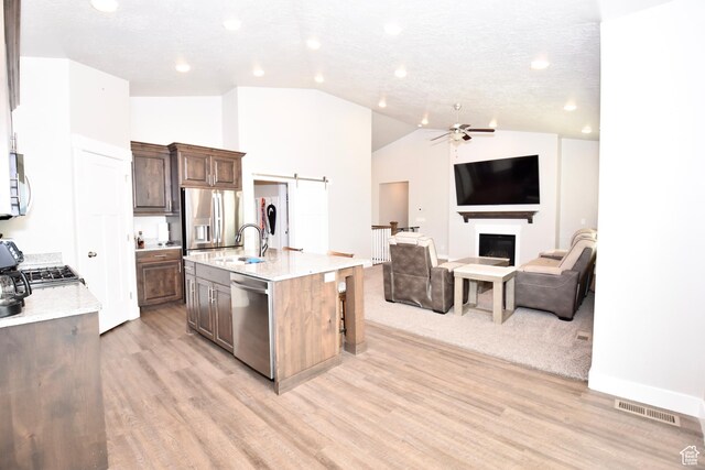 397 S Trejo Ridge Rd E, Grantsville, UT 84029 - kitchen featuring stainless steel appliances, open floor plan, ceiling fan, light wood-style floors, and vaulted ceiling