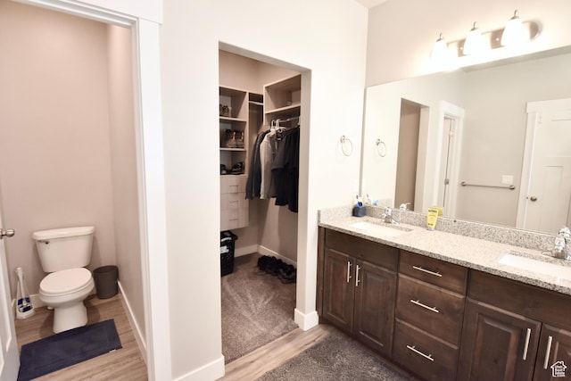 397 S Trejo Ridge Rd E, Grantsville, UT 84029 - bathroom featuring double vanity, wood finished floors, and a walk in closet