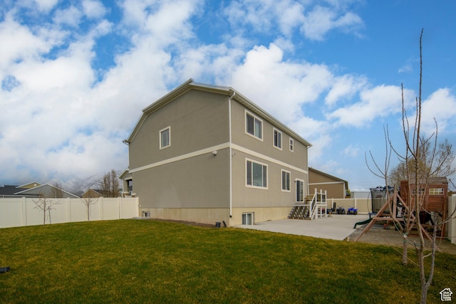 6459 N Star Discovery Way W, Stansbury Park, UT 84074 - back of house with a patio area, a fenced backyard, and stucco siding