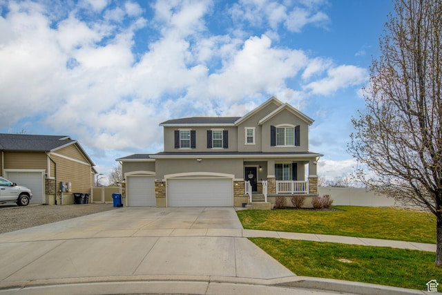 6459 N Star Discovery Way W, Stansbury Park, UT 84074 - view of front of home featuring stucco siding, driveway, a front lawn, covered porch, and stone siding