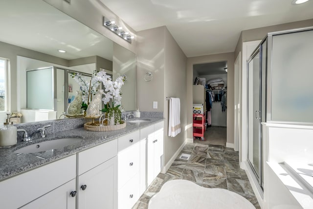 6459 N Star Discovery Way W, Stansbury Park, UT 84074 - bathroom featuring a shower stall, double vanity, a spacious closet, and recessed lighting