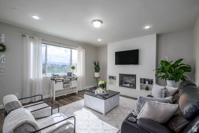 6459 N Star Discovery Way W, Stansbury Park, UT 84074 - living area featuring light wood-style floors, a fireplace, and recessed lighting