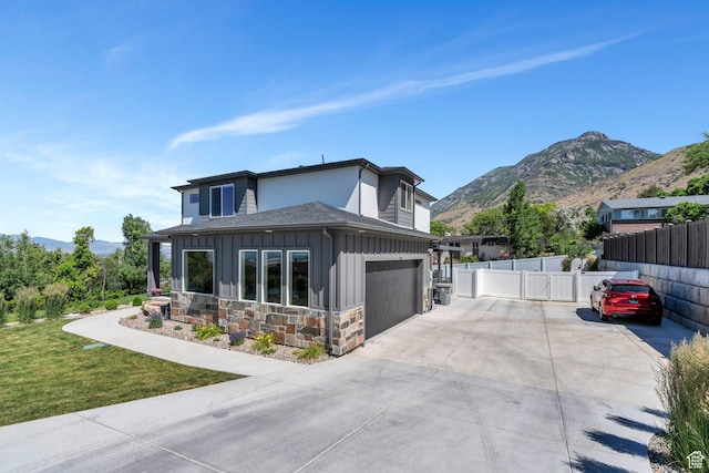 113 N 1400 E, Pleasant Grove, UT 84062 - view of front facade with board and batten siding, a mountain view, driveway, and stone siding