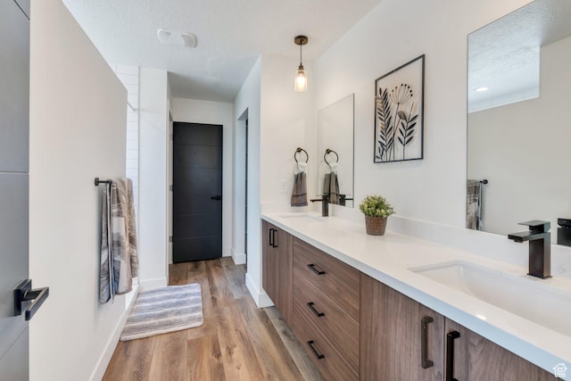 113 N 1400 E, Pleasant Grove, UT 84062 - bathroom featuring double vanity, wood finished floors, and a textured ceiling