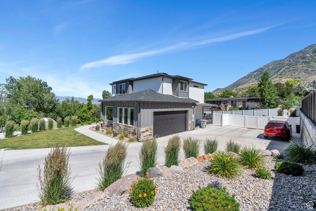 113 N 1400 E, Pleasant Grove, UT 84062 - view of front of property featuring driveway, a mountain view, stone siding, board and batten siding, and roof with shingles