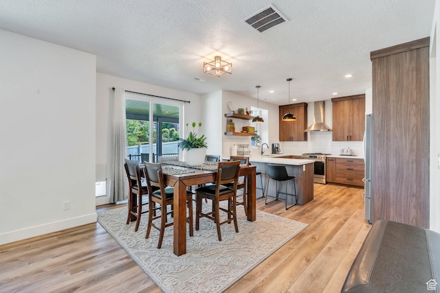113 N 1400 E, Pleasant Grove, UT 84062 - dining room featuring light wood-style floors, a textured ceiling, and recessed lighting