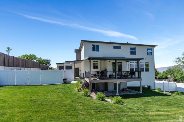 113 N 1400 E, Pleasant Grove, UT 84062 - back of house with a gate, stucco siding, a fenced backyard, and a deck