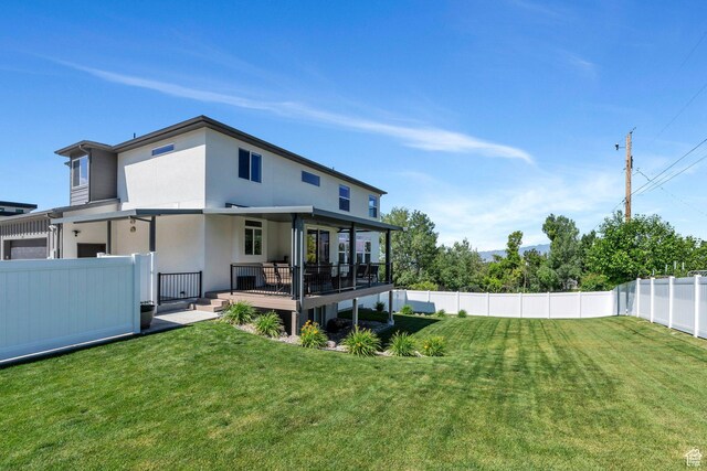 113 N 1400 E, Pleasant Grove, UT 84062 - back of house with a fenced backyard, a deck, and stucco siding