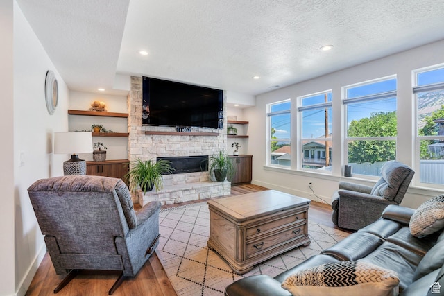 113 N 1400 E, Pleasant Grove, UT 84062 - living area with a textured ceiling, light wood-style floors, a fireplace, and recessed lighting
