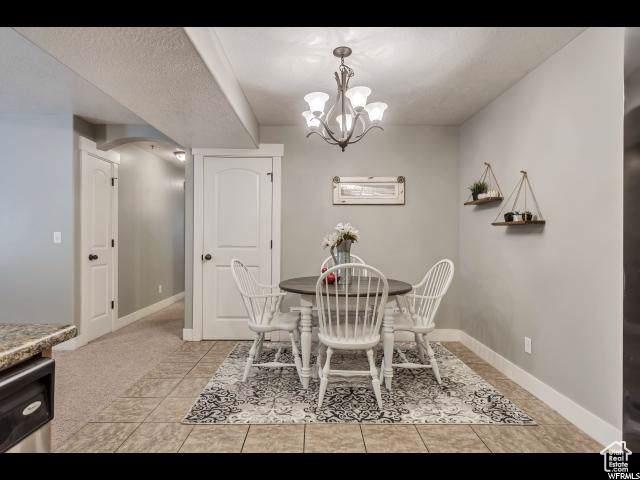 1045 S 1700 W Unit 320, Payson, UT 84651 - dining area with a chandelier and light tile patterned floors