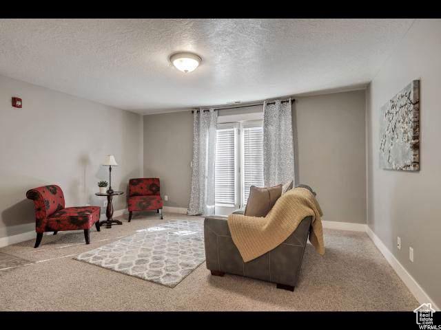 1045 S 1700 W Unit 320, Payson, UT 84651 - living area with a textured ceiling and carpet floors