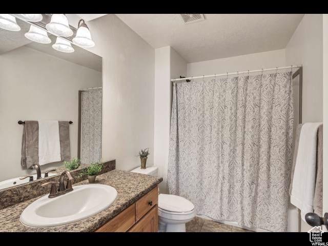 1045 S 1700 W Unit 320, Payson, UT 84651 - full bath with vanity, tile patterned floors, and curtained shower