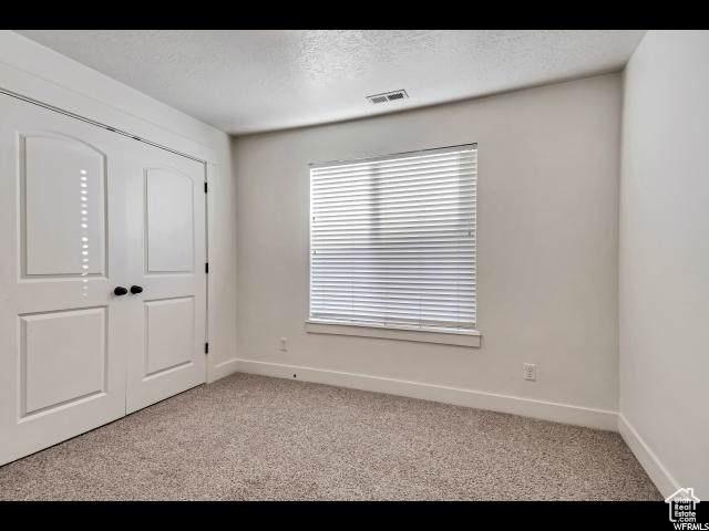 1045 S 1700 W Unit 320, Payson, UT 84651 - carpeted empty room featuring baseboards and a textured ceiling