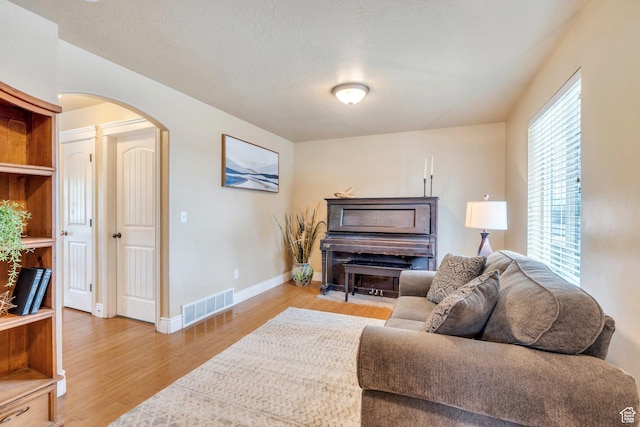 1198 N Reese Dr, Provo, UT 84601 - living area with arched walkways and wood finished floors