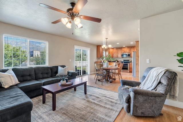 1198 N Reese Dr, Provo, UT 84601 - living area featuring a chandelier, ceiling fan, light wood-style floors, a textured ceiling, and recessed lighting