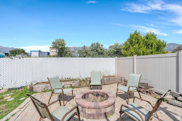 1198 N Reese Dr, Provo, UT 84601 - fenced backyard with a fire pit, a patio area, and a mountain view