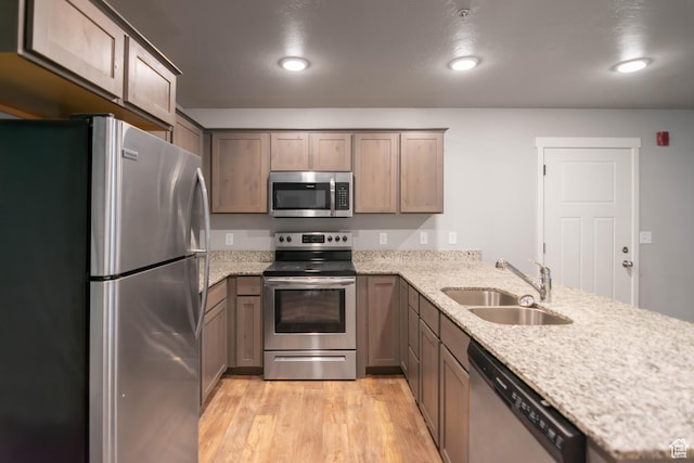 477 S 850 E, American Fork, UT 84003 - kitchen with appliances with stainless steel finishes, a peninsula, light wood-style floors, light stone counters, and recessed lighting
