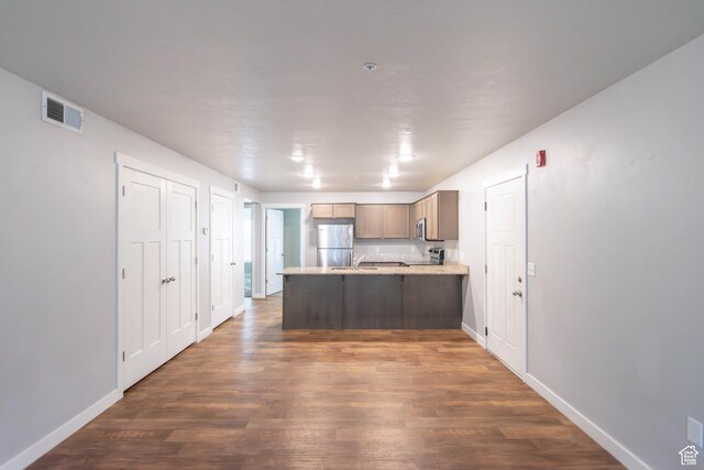477 S 850 E, American Fork, UT 84003 - kitchen featuring appliances with stainless steel finishes, a peninsula, dark wood-style flooring, and light countertops