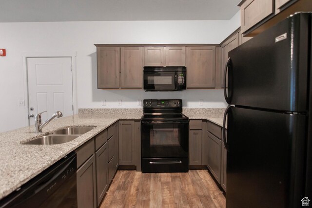 477 S 850 E, American Fork, UT 84003 - kitchen featuring black appliances, light wood finished floors, light stone countertops, and a peninsula