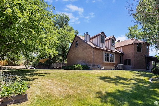 2673 E Toni Cir S, Cottonwood Heights, UT 84121 - rear view of property featuring brick siding, a yard, a chimney, and board and batten siding