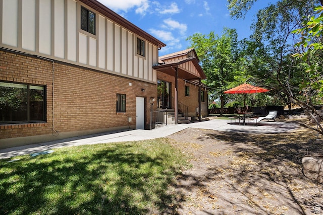 2673 E Toni Cir S, Cottonwood Heights, UT 84121 - back of property featuring brick siding, a patio, and board and batten siding