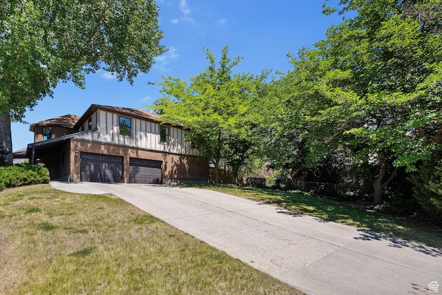 2673 E Toni Cir S, Cottonwood Heights, UT 84121 - tudor house featuring a garage, driveway, and board and batten siding