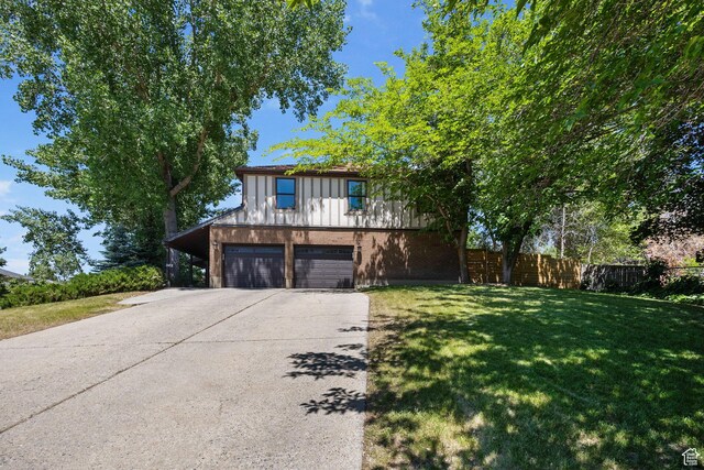 2673 E Toni Cir S, Cottonwood Heights, UT 84121 - view of front of house featuring driveway, an attached garage, board and batten siding, and brick siding