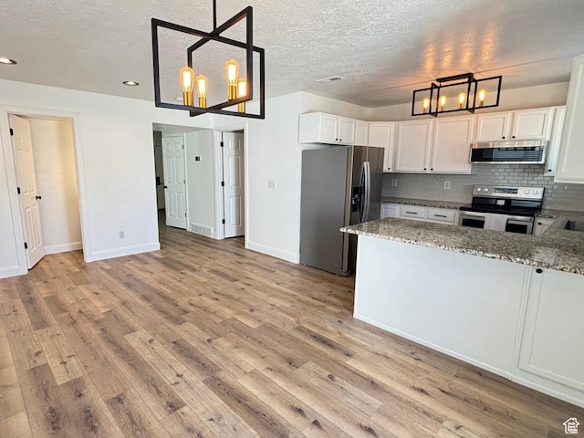 1165 N 2850 W, Provo, UT 84601 - kitchen with stainless steel appliances, a chandelier, light wood-style flooring, backsplash, and light stone countertops
