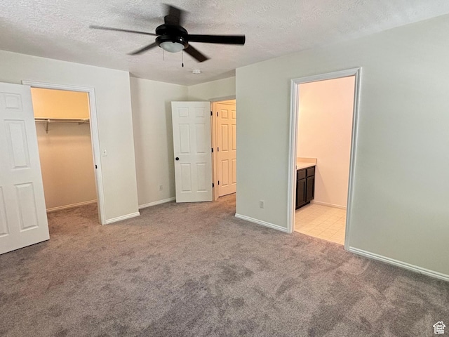 1165 N 2850 W, Provo, UT 84601 - unfurnished bedroom with light colored carpet, a walk in closet, a textured ceiling, a closet, and a ceiling fan