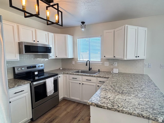 1165 N 2850 W, Provo, UT 84601 - kitchen featuring stainless steel appliances, a peninsula, wood finished floors, and white cabinetry