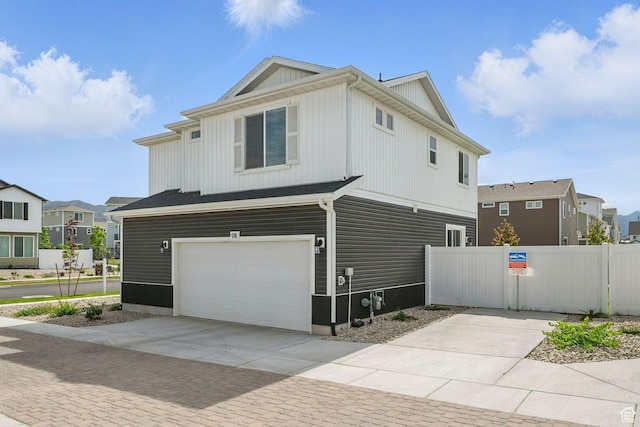 98 E Stroll Ave Unit 809, Saratoga Springs, UT 84045 - view of property exterior with an attached garage, concrete driveway, and a residential view