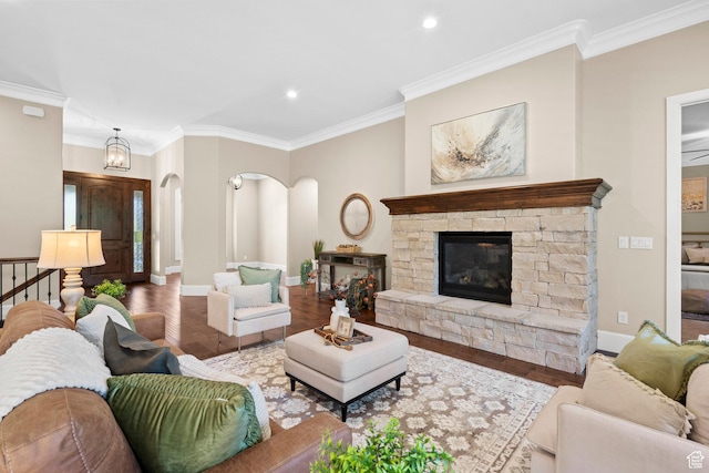 2209 E Viscaya Dr, Draper, UT 84020 - living room featuring arched walkways, wood finished floors, crown molding, a stone fireplace, and recessed lighting