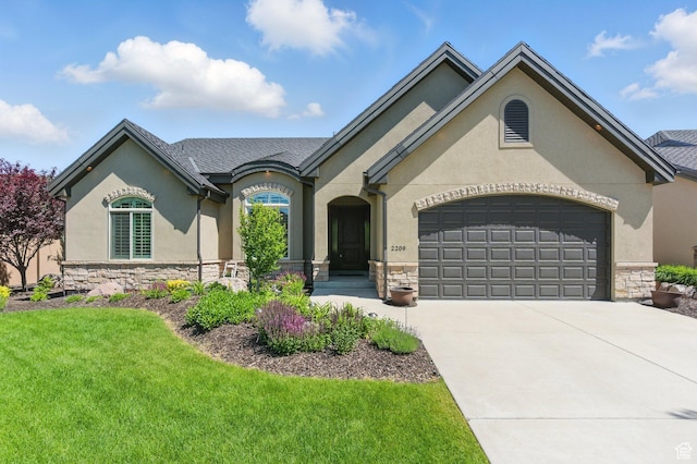2209 E Viscaya Dr, Draper, UT 84020 - french country style house featuring stone siding, a garage, stucco siding, concrete driveway, and a front yard