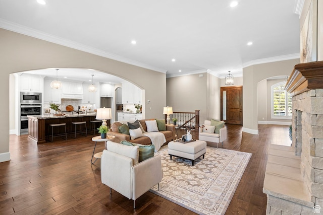 2209 E Viscaya Dr, Draper, UT 84020 - living area with arched walkways, recessed lighting, dark wood finished floors, and ornamental molding