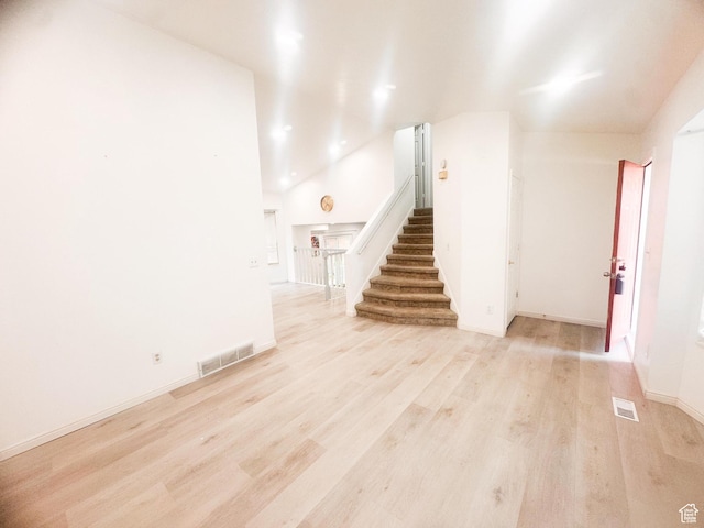 5351 S Royal Autumn Cir, Taylorsville, UT 84129 - unfurnished living room with stairway, light wood finished floors, lofted ceiling, and recessed lighting