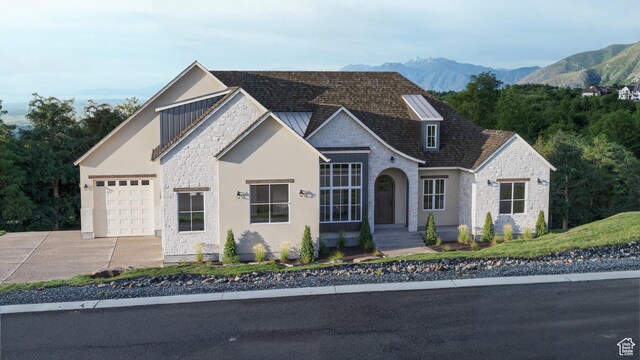 1087 S Loafer Dr, Woodland Hills, UT 84653 - view of front facade with stone siding, a garage, driveway, and a mountain view