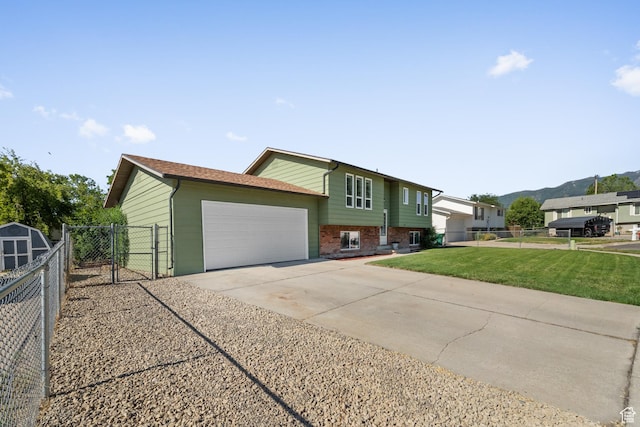 1726 W 1375 N, Layton, UT 84041 - view of side of home with a garage, a gate, brick siding, and driveway