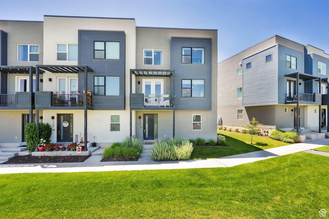 6366 W Sugarcane Dr S Unit 310, South Jordan, UT 84009 - view of front of property with a balcony, stucco siding, and a front yard