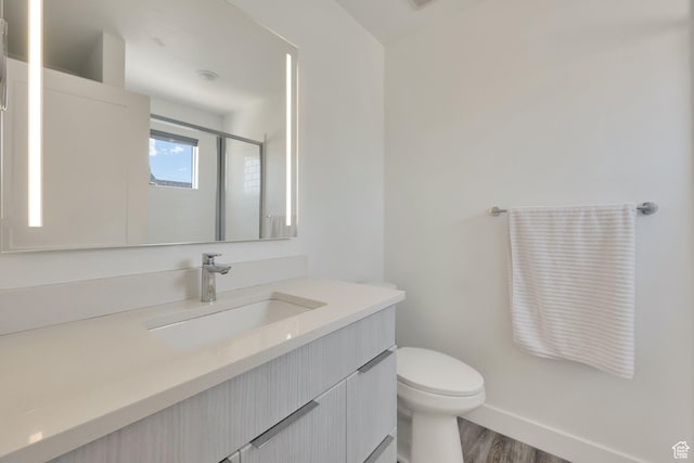 6366 W Sugarcane Dr S Unit 310, South Jordan, UT 84009 - full bathroom featuring vanity, wood finished floors, and a shower with door