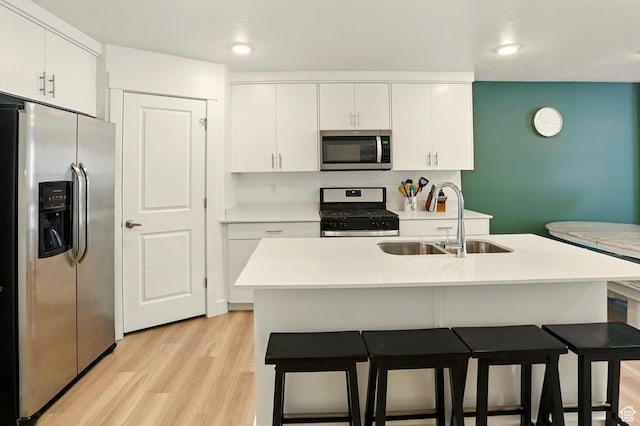 1754 N 300 E Unit 114, North Ogden, UT 84414 - kitchen with stainless steel appliances, white cabinets, light wood finished floors, a kitchen breakfast bar, and recessed lighting