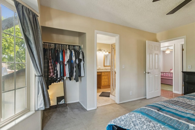 3285 W 6775 S, West Jordan, UT 84084 - bedroom with a closet, carpet flooring, connected bathroom, a textured ceiling, and a walk in closet