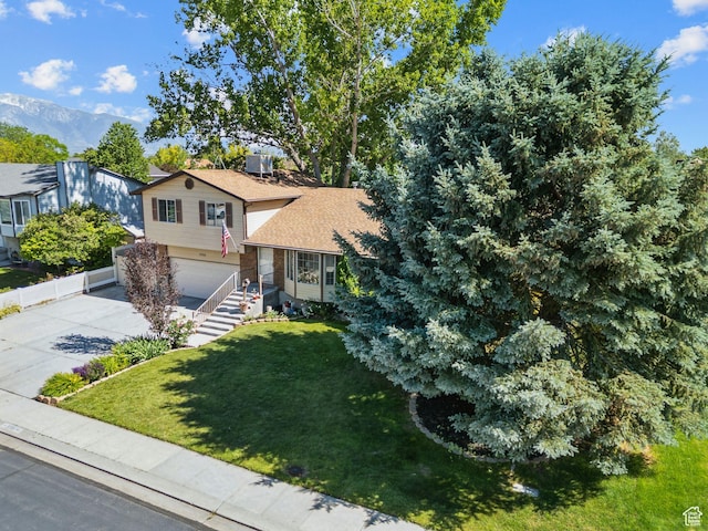 3285 W 6775 S, West Jordan, UT 84084 - split level home featuring an attached garage, a front yard, concrete driveway, and roof with shingles